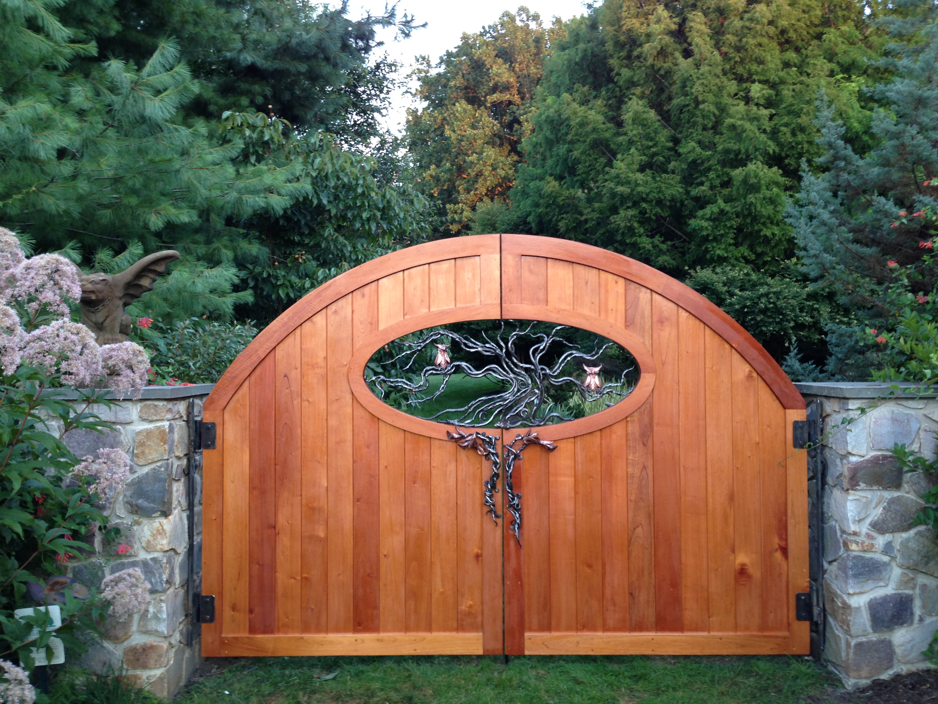 Spanish Cedar garden entry gate. Metal sculpture by greg Leavitt