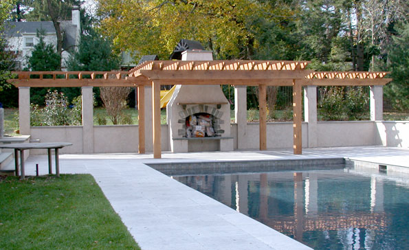 White oak pergola and arbor frame a poolside fireplace wall.